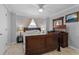 Cozy bedroom with a wooden bed frame, ceiling fan, and neutral color scheme at 113 Avalon Dr, Ormond Beach, FL 32176