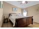 Bedroom with a ceiling fan, queen bed, and tropical decor at 113 Avalon Dr, Ormond Beach, FL 32176