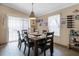 Well-lit dining room with wood floors and table adjacent to a sliding glass door for easy access to outside at 113 Avalon Dr, Ormond Beach, FL 32176
