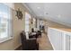 Upstairs hallway sitting area with wood floors, neutral walls, and a glimpse into the kitchen at 113 Avalon Dr, Ormond Beach, FL 32176