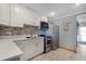 Well-lit kitchen with stainless steel appliances, grey walls, and tile backsplash at 113 Avalon Dr, Ormond Beach, FL 32176