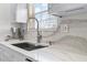 Updated kitchen with stainless steel sink, modern faucet, and stylish marble backsplash at 113 Avalon Dr, Ormond Beach, FL 32176