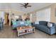 Cozy living room with comfortable sofas and a decorative ceiling fan, offering a relaxing atmosphere at 113 Avalon Dr, Ormond Beach, FL 32176