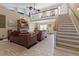 Spacious living room with high ceilings, wood floors, stone fireplace, and comfortable leather sofas at 113 Avalon Dr, Ormond Beach, FL 32176