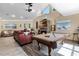 Spacious living room featuring a fireplace, pool table, vaulted ceiling, and hardwood floors for entertaining at 113 Avalon Dr, Ormond Beach, FL 32176