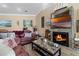 Cozy living room with a stone fireplace, mounted TV, and nautical-themed decor at 113 Avalon Dr, Ormond Beach, FL 32176