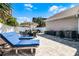 Charming patio area featuring pavers, outdoor seating, lounge chairs and a privacy fence at 113 Avalon Dr, Ormond Beach, FL 32176