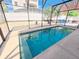 Refreshing in-ground pool enclosed within a screened lanai, perfect for relaxation and privacy at 113 Avalon Dr, Ormond Beach, FL 32176