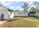 The backyard includes grassy areas, sheds for storage, and partial fencing at 1140 W Seminole Trl, Bartow, FL 33830