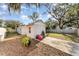 View of backyard with storage shed, partial fencing, and mature trees at 1140 W Seminole Trl, Bartow, FL 33830