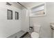 This bathroom features a sleek walk-in shower, modern tile, and a window for natural light at 1140 W Seminole Trl, Bartow, FL 33830