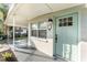 Inviting front porch featuring a charming entrance with a teal door at 1140 W Seminole Trl, Bartow, FL 33830