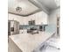 Bright kitchen featuring a stainless steel refrigerator, breakfast bar, and blue backsplash at 1140 W Seminole Trl, Bartow, FL 33830
