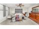 Inviting bedroom with wood-look floors, a ceiling fan, decorative textiles, and neutral tones at 1140 W Seminole Trl, Bartow, FL 33830