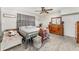 Bright main bedroom featuring neutral walls, wood-look floors, and traditional-style wooden dresser at 1140 W Seminole Trl, Bartow, FL 33830