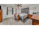 Serene bedroom features wood-look floors, a ceiling fan, and calming neutral color palette at 1140 W Seminole Trl, Bartow, FL 33830