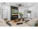 Bright living room featuring a contemporary fireplace, TV, and access to the outdoor patio at 15320 Grand Haven Dr, Clermont, FL 34714