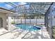 Beautiful screened-in pool and spa with safety fence, offering both fun and peace of mind at 15320 Grand Haven Dr, Clermont, FL 34714