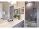 Contemporary bathroom features a large mirror, a gray tiled shower and modern fixtures at 1593 Evening Summit Cir, Minneola, FL 34715