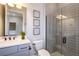 Contemporary bathroom featuring a glass-enclosed shower, gray vanity with white countertop, and stylish décor at 1593 Evening Summit Cir, Minneola, FL 34715