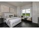 Bright bedroom features a neutral color palette, hardwood floors, and a window seat at 1593 Evening Summit Cir, Minneola, FL 34715
