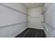 Walk-in closet with wooden floors and metal shelving on all sides, offering ample storage space at 1593 Evening Summit Cir, Minneola, FL 34715
