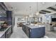 Bright, open kitchen with an island, stainless steel dishwasher, and views of dining and living spaces at 1593 Evening Summit Cir, Minneola, FL 34715