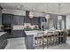 Modern kitchen featuring gray cabinetry, stainless steel appliances, a center island, and stylish pendant lighting at 1593 Evening Summit Cir, Minneola, FL 34715