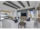 Comfortable living room with beamed ceiling, a large TV, stylish furniture, and access to an outdoor living area at 1593 Evening Summit Cir, Minneola, FL 34715