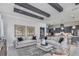 Comfortable living space with beamed ceiling, a gray kitchen, open floor plan, and stylish furniture at 1593 Evening Summit Cir, Minneola, FL 34715