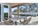 Covered patio features sleek dining set and view of sparkling pool and water feature at 1593 Evening Summit Cir, Minneola, FL 34715