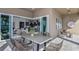 Covered patio with modern dining set and view of open concept living area at 1593 Evening Summit Cir, Minneola, FL 34715