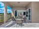Covered patio offers sleek dining set with view of green space and open concept living at 1593 Evening Summit Cir, Minneola, FL 34715