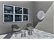 Cozy patio with modern chairs, stylish stools, decorative wall art, and gray pavers at 1593 Evening Summit Cir, Minneola, FL 34715