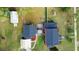 Aerial view of the house, showing roof, yard, garage, and proximity to other buildings at 1601 E 1St Ave, Mount Dora, FL 32757