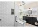 Sleek bathroom with modern fixtures, glass shower, and tiled walls at 1601 E 1St Ave, Mount Dora, FL 32757