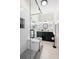 Modern bathroom features a glass shower, black vanity, and patterned tile floor at 1601 E 1St Ave, Mount Dora, FL 32757