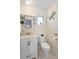 Well-lit bathroom features a vanity with storage, a toilet, and neutral decor, enhanced by a dragonfly wall ornament at 1601 E 1St Ave, Mount Dora, FL 32757