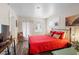 Comfortable bedroom features a striking red quilt, colorful rug, and bright accents at 1601 E 1St Ave, Mount Dora, FL 32757