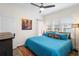 Bright bedroom with a large window, a ceiling fan, and a colorful rug at 1601 E 1St Ave, Mount Dora, FL 32757
