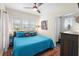 Cozy bedroom with a large window, a ceiling fan, and a colorful rug at 1601 E 1St Ave, Mount Dora, FL 32757