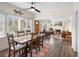 Charming dining room adjacent to living room with dark wood table and ample natural light at 1601 E 1St Ave, Mount Dora, FL 32757