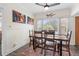 Well-lit dining room with eclectic art, ceiling fan, and large window overlooking the yard at 1601 E 1St Ave, Mount Dora, FL 32757