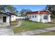 Exterior shot of a charming home with well-maintained lawn and inviting outdoor seating, set against a clear blue sky at 1601 E 1St Ave, Mount Dora, FL 32757