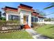 Charming home with terra cotta roof, manicured landscaping, and inviting front porch at 1601 E 1St Ave, Mount Dora, FL 32757