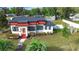 Charming white two-story home with well-maintained landscaping and a red-tiled roof at 1601 E 1St Ave, Mount Dora, FL 32757