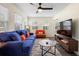 Bright living room featuring a blue couch and a television at 1601 E 1St Ave, Mount Dora, FL 32757