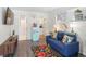 Cozy living area with colorful decor, including a blue sofa, floral rug, and unique decorative accents at 1601 E 1St Ave, Mount Dora, FL 32757