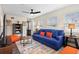 Bright living room featuring a blue couch and plenty of windows at 1601 E 1St Ave, Mount Dora, FL 32757