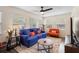 Bright living room featuring a blue couch and several windows at 1601 E 1St Ave, Mount Dora, FL 32757